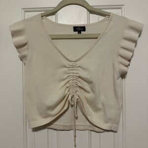 Cream shirt with ruffle details on sleeve